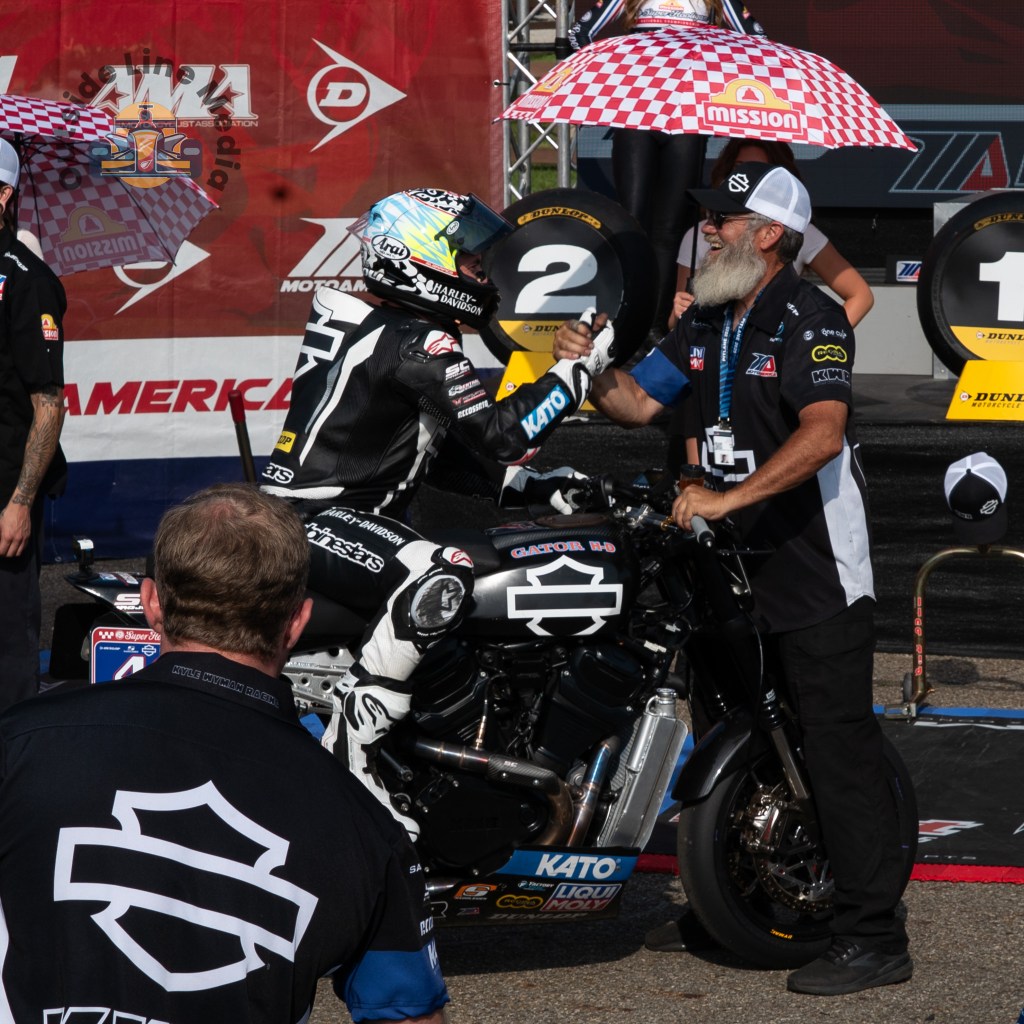 James Rispoli being congratulated by a Harley-Davidson team member after winning race 1 at Mid-Ohio